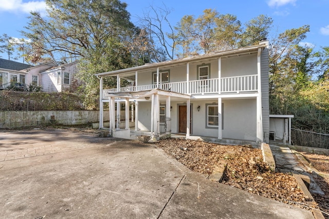 view of front of house featuring covered porch and a balcony