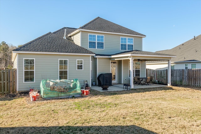 back of property with a yard and a patio area