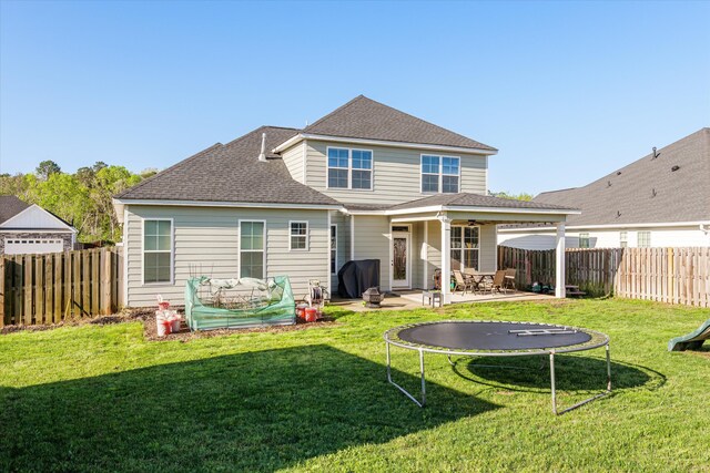 256 Dublin Loop, Grovetown, GA 30813 - back of property with a trampoline, a patio area, ceiling fan, and roof with shingles