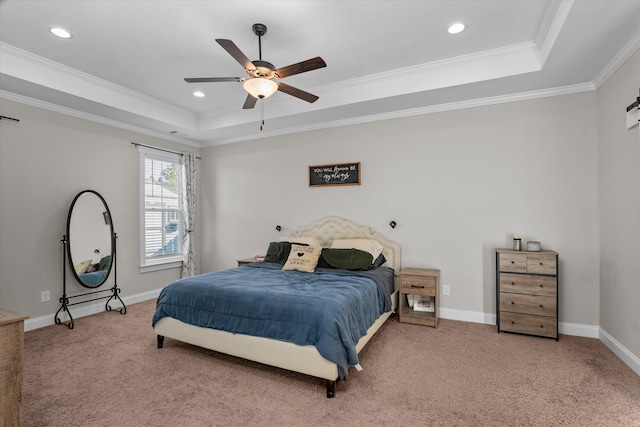 bedroom with ornamental molding, carpet flooring, and a tray ceiling