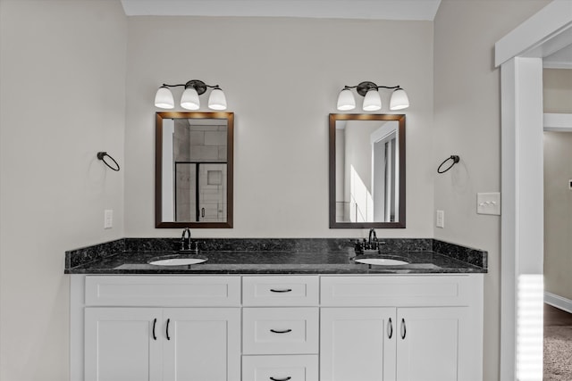 bathroom with walk in shower and vanity