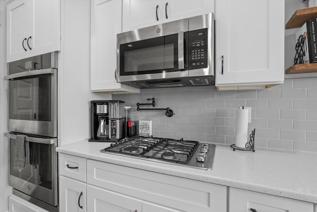 256 Dublin Loop, Grovetown, GA 30813 - kitchen featuring stainless steel appliances, open shelves, white cabinets, backsplash, and light stone countertops