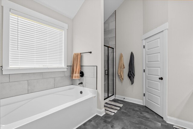 256 Dublin Loop, Grovetown, GA 30813 - full bathroom featuring a garden tub, vaulted ceiling, a stall shower, and baseboards