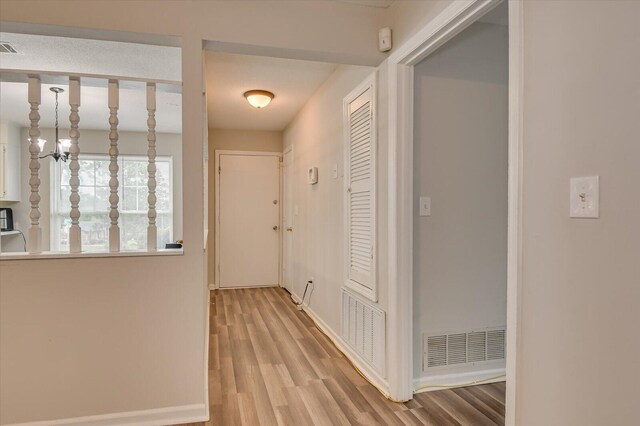 hall with light hardwood / wood-style floors