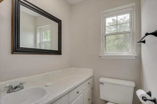 bathroom featuring vanity and toilet