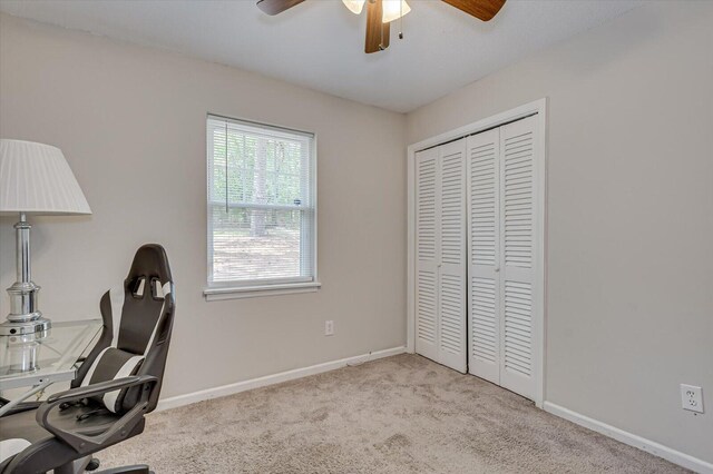 office space with light carpet and ceiling fan