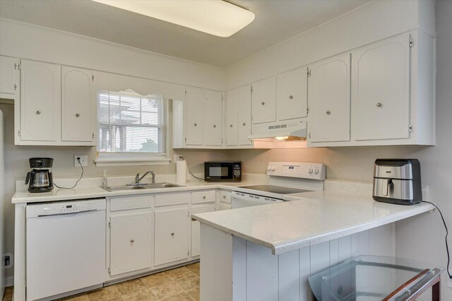 kitchen with white dishwasher, white cabinets, kitchen peninsula, and range with electric cooktop