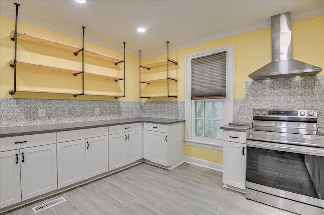 1107 Heard Ave, Augusta, GA 30904 - kitchen with stainless steel range with electric stovetop, wall chimney range hood, crown molding, decorative backsplash, and open shelves