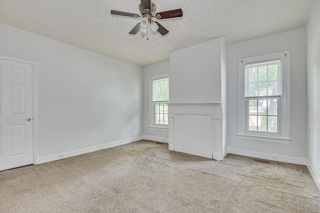 1107 Heard Ave, Augusta, GA 30904 - unfurnished living room with a textured ceiling, plenty of natural light, carpet floors, and ceiling fan