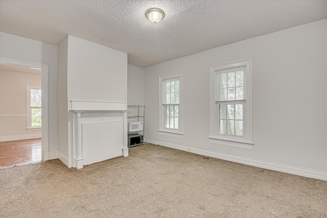 1107 Heard Ave, Augusta, GA 30904 - unfurnished living room featuring light colored carpet and a textured ceiling
