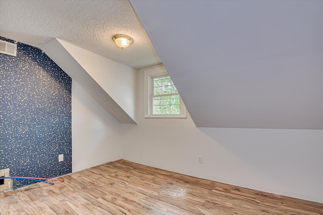 1107 Heard Ave, Augusta, GA 30904 - bonus room featuring wallpapered walls, wood finished floors, an accent wall, lofted ceiling, and a textured ceiling