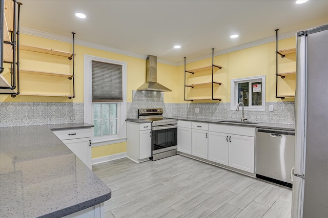 1107 Heard Ave, Augusta, GA 30904 - kitchen with appliances with stainless steel finishes, wall chimney range hood, open shelves, ornamental molding, and light stone counters