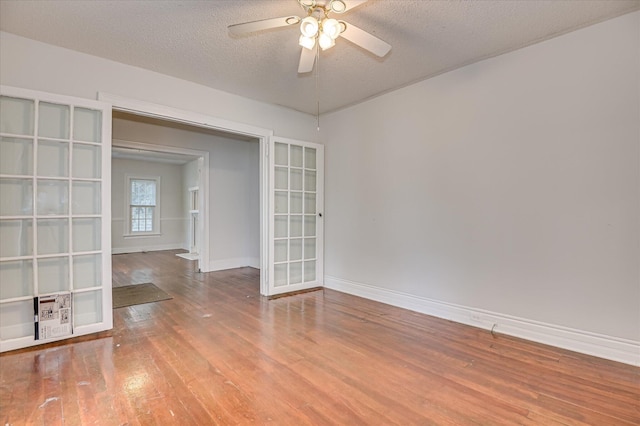 1107 Heard Ave, Augusta, GA 30904 - empty room with wood finished floors, ceiling fan, a textured ceiling, and french doors
