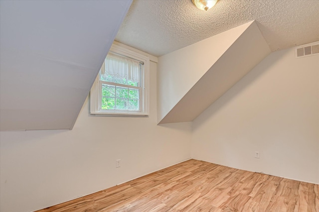 1107 Heard Ave, Augusta, GA 30904 - additional living space with wood finished floors, lofted ceiling, and a textured ceiling