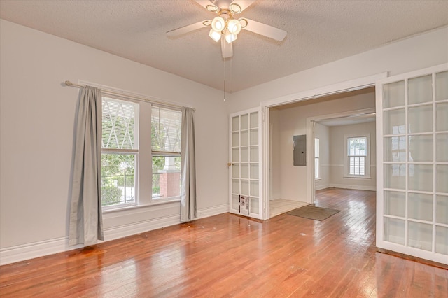 1107 Heard Ave, Augusta, GA 30904 - unfurnished room featuring hardwood / wood-style flooring, a textured ceiling, a ceiling fan, electric panel, and french doors