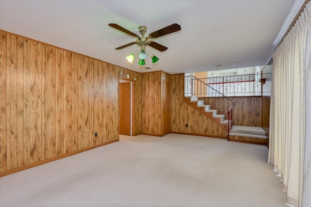 904 Big Hunt Rd, Augusta, GA 30907 - unfurnished living room with wood walls, ceiling fan, carpet flooring, and stairway