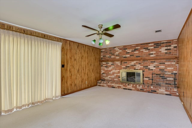 904 Big Hunt Rd, Augusta, GA 30907 - unfurnished living room featuring wood walls, carpet floors, ceiling fan, and a fireplace