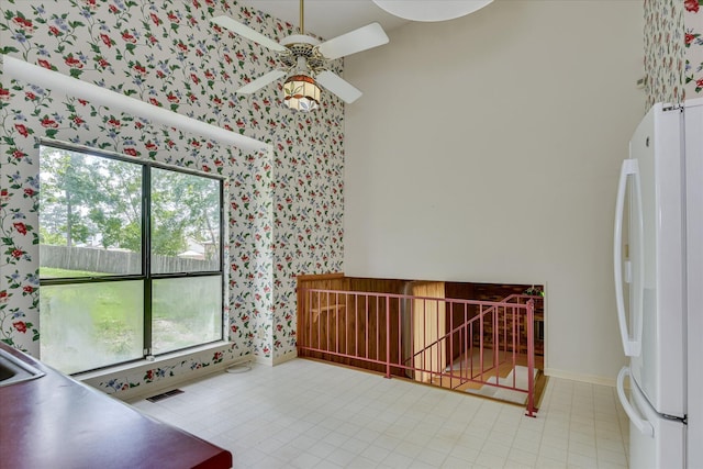 904 Big Hunt Rd, Augusta, GA 30907 - unfurnished dining area featuring wallpapered walls, ceiling fan, and a high ceiling