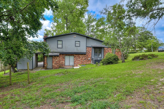 904 Big Hunt Rd, Augusta, GA 30907 - rear view of house featuring a lawn, a chimney, and brick siding