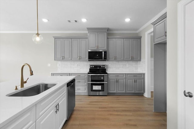 5511 Sweetwater Dr, Grovetown, GA 30813 - kitchen with stainless steel appliances, gray cabinetry, ornamental molding, backsplash, and light countertops