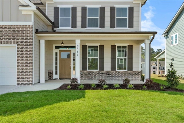 5511 Sweetwater Dr, Grovetown, GA 30813 - doorway to property featuring brick siding, covered porch, a yard, and board and batten siding