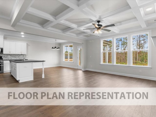 kitchen featuring stainless steel appliances, white cabinetry, a center island with sink, and dark wood-type flooring