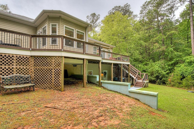 back of house with a lawn and a wooden deck