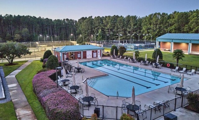 view of pool featuring a lawn and a patio