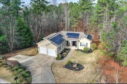 view of front of property featuring solar panels and a garage