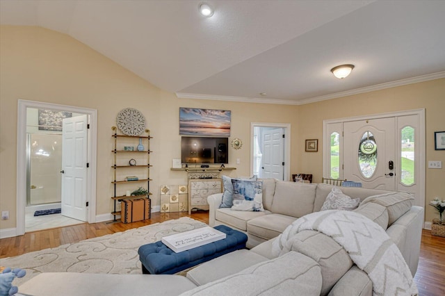 living room with light hardwood / wood-style floors and vaulted ceiling