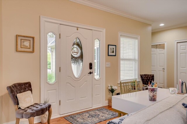 entrance foyer featuring hardwood / wood-style floors and crown molding