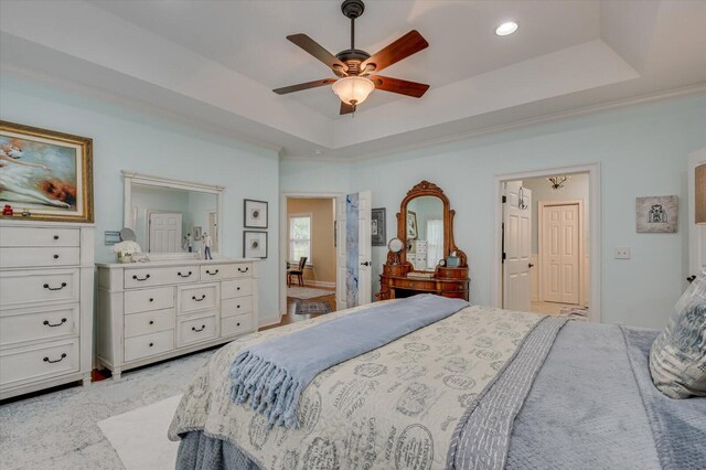 bedroom featuring a tray ceiling, ceiling fan, and ornamental molding