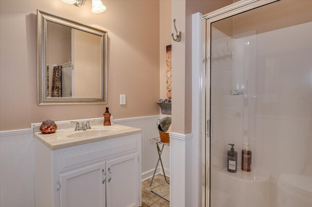 bathroom featuring vanity, tile patterned floors, and a shower with door