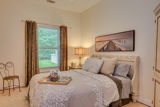 carpeted bedroom featuring multiple windows