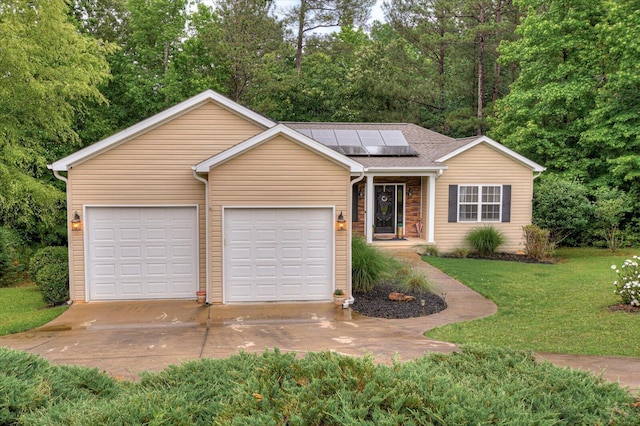 single story home with a garage, a front yard, and solar panels