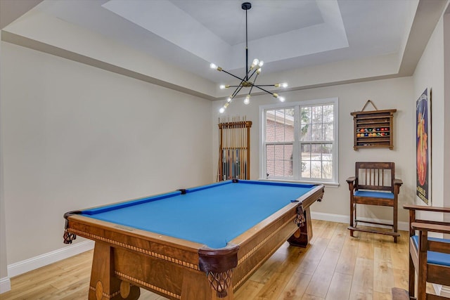 game room featuring light wood-type flooring, a raised ceiling, billiards, and baseboards