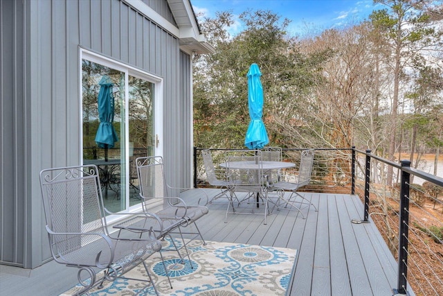 wooden terrace with outdoor dining area