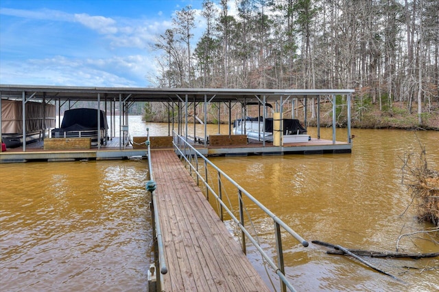 dock area with a water view and boat lift