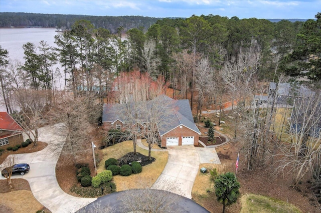 aerial view featuring a forest view and a water view