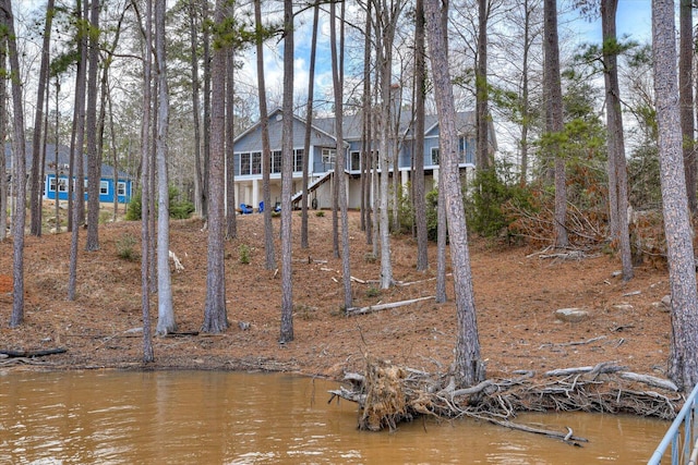 view of yard featuring a water view and stairway