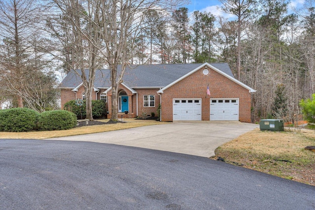 ranch-style home with brick siding, driveway, an attached garage, and roof with shingles