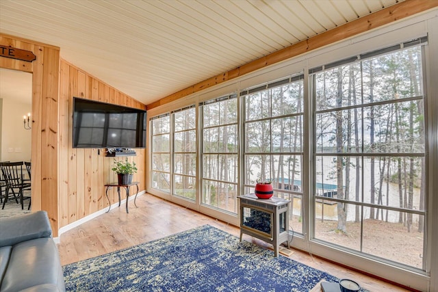 unfurnished sunroom featuring lofted ceiling