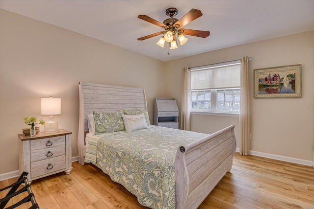 bedroom featuring baseboards, ceiling fan, and light wood finished floors