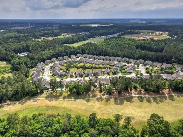 drone / aerial view featuring a forest view and a residential view