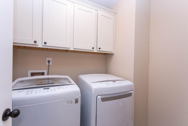 laundry room featuring cabinet space and washing machine and dryer