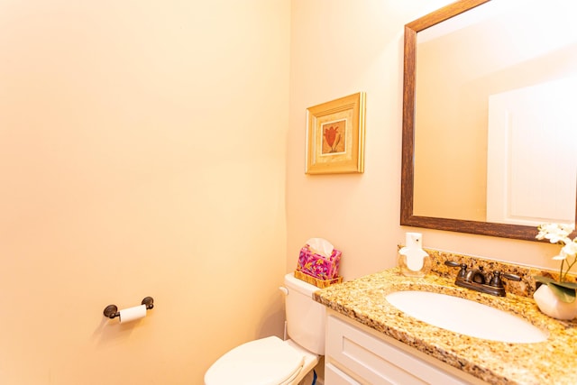 bathroom with toilet and vanity