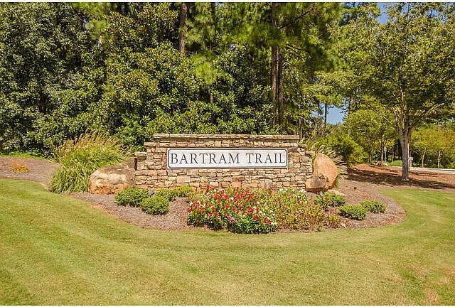community / neighborhood sign featuring a lawn