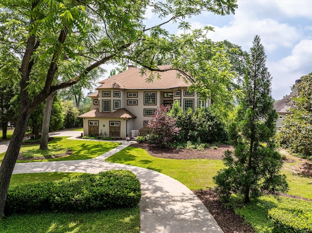 197 River Bend Dr, Clarks Hill, SC 29821 - view of front facade with stucco siding, a front yard, a shingled roof, and a chimney