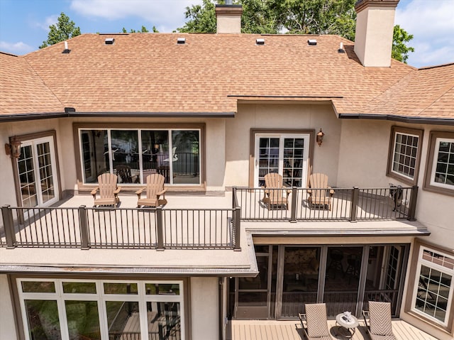 197 River Bend Dr, Clarks Hill, SC 29821 - back of property with a balcony, a chimney, a shingled roof, and stucco siding