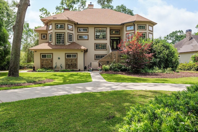 197 River Bend Dr, Clarks Hill, SC 29821 - view of front facade with stucco siding, a front yard, a chimney, and roof with shingles